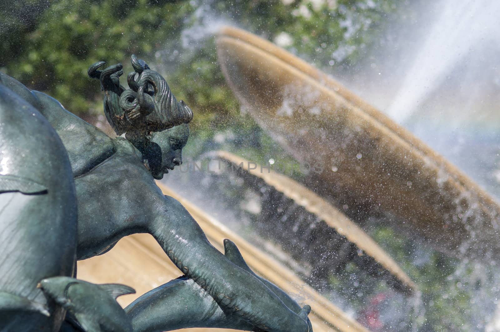 Detail of statue by water fountain in Trafalgar Square, central London, UK
