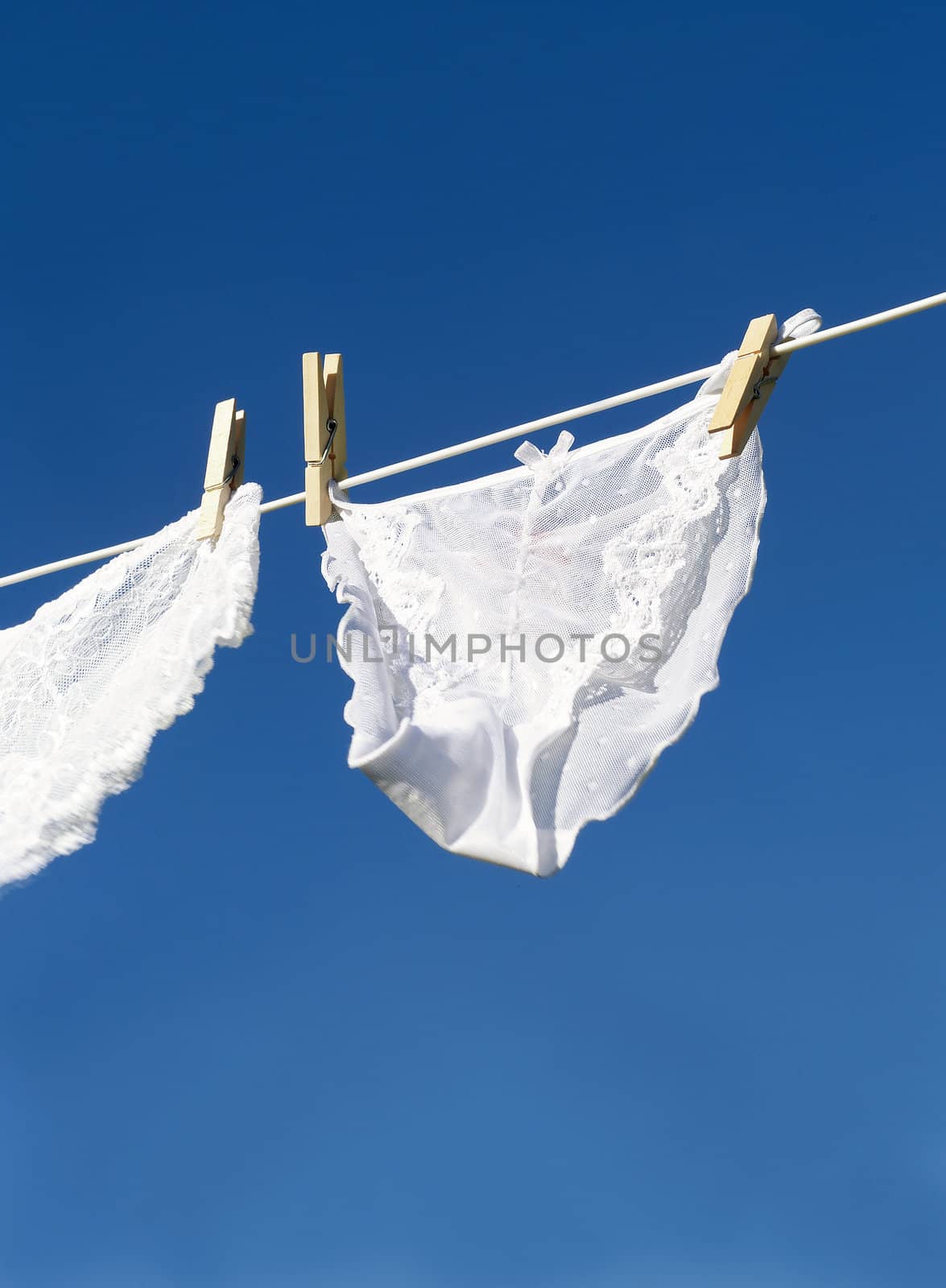 Female underwear on a clothesline towards blue sky