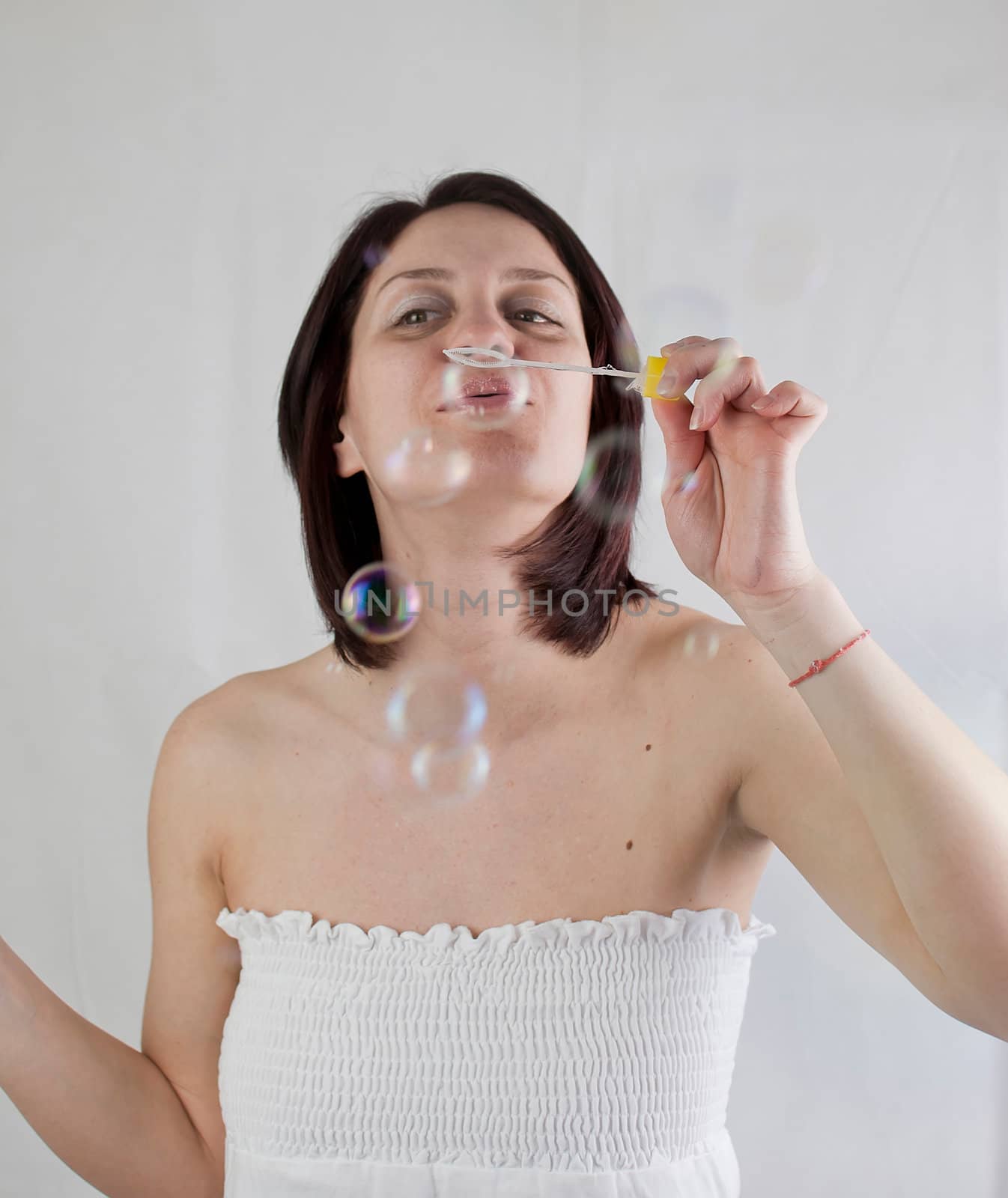 a beauty young woman blowing soap bubbles