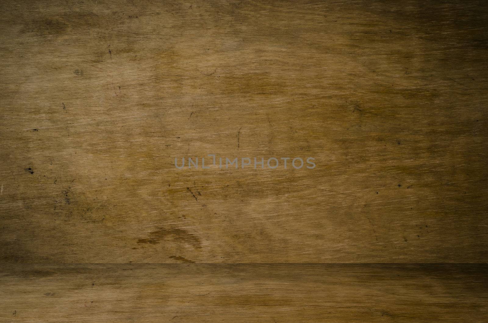 A grungy woodgrain interior wall and floor, with scratches and stains. 