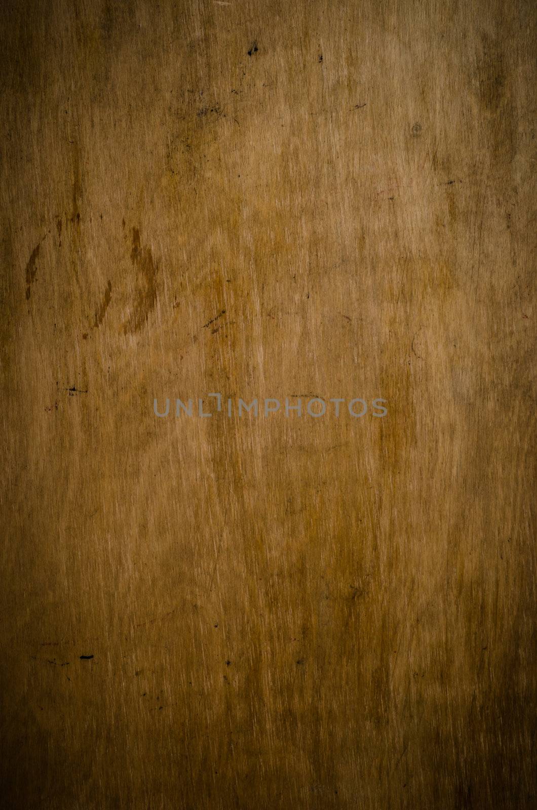 An old dark wood panel with stains, scratches and vignette provides a grunge style background. 