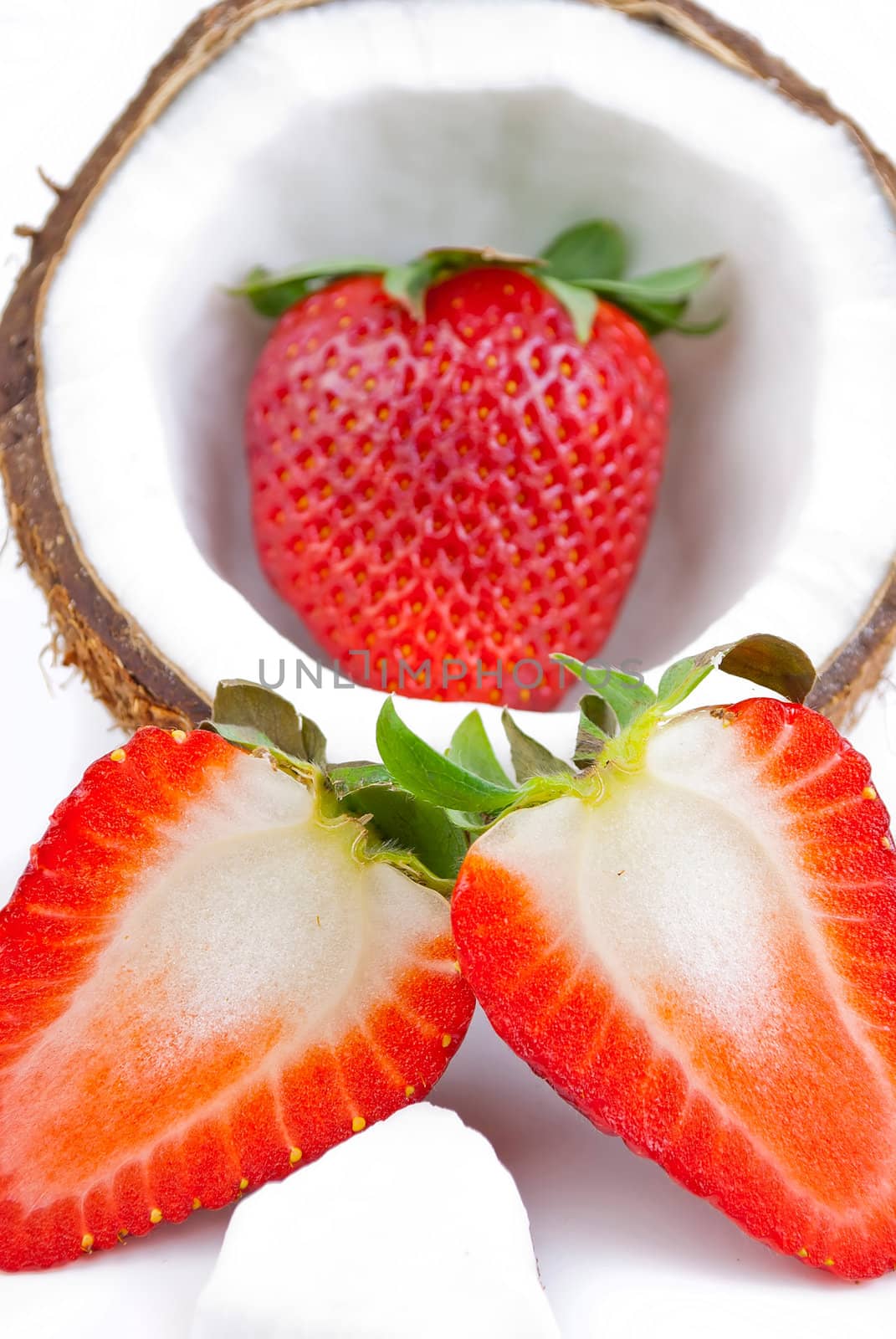 healthy fresh fruits - strawberries and coconut isolated on white background