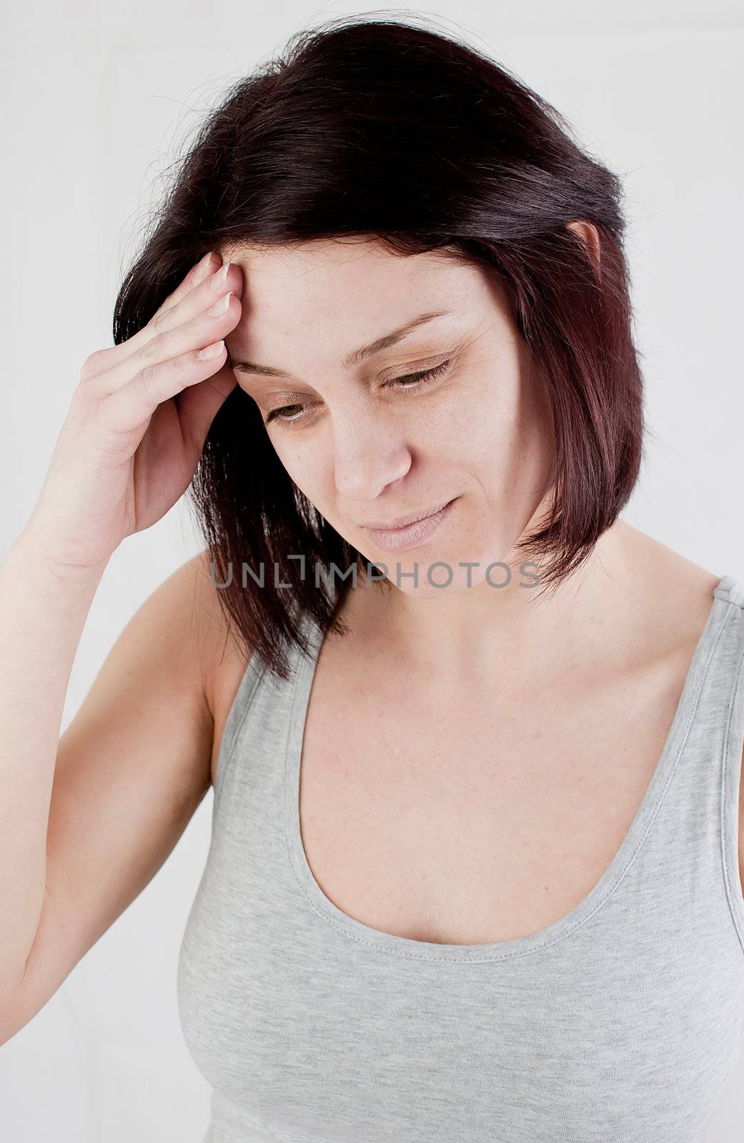 young woman with headache making massage to avoid pain