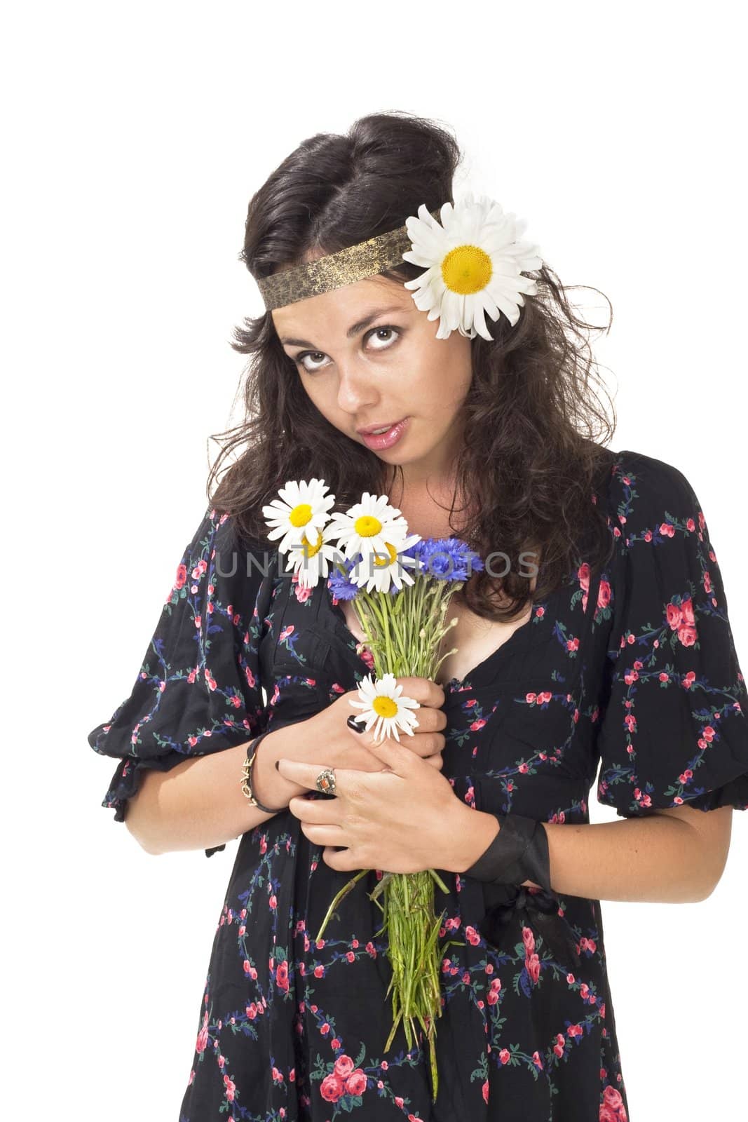 Young girl dressed like hippie with bunch of flowers posing to the camera