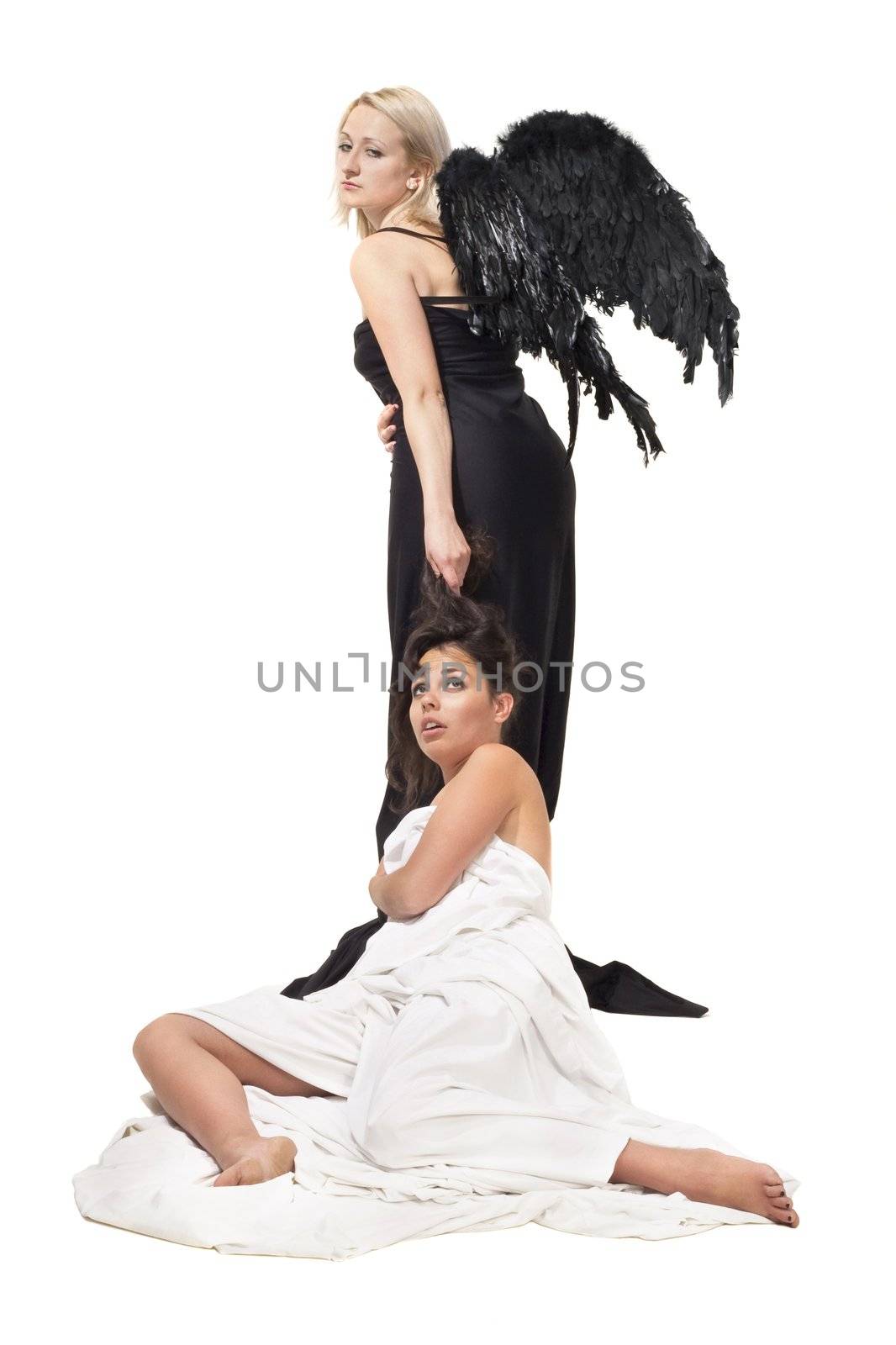 Two girls representing scene between angel and devil