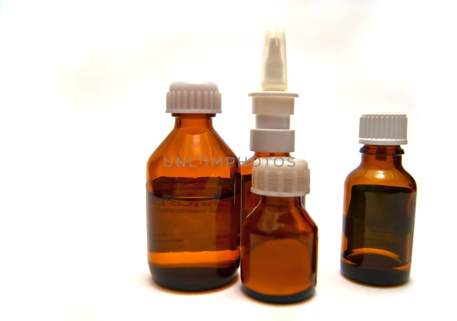 Four bottles of different medicine on white background