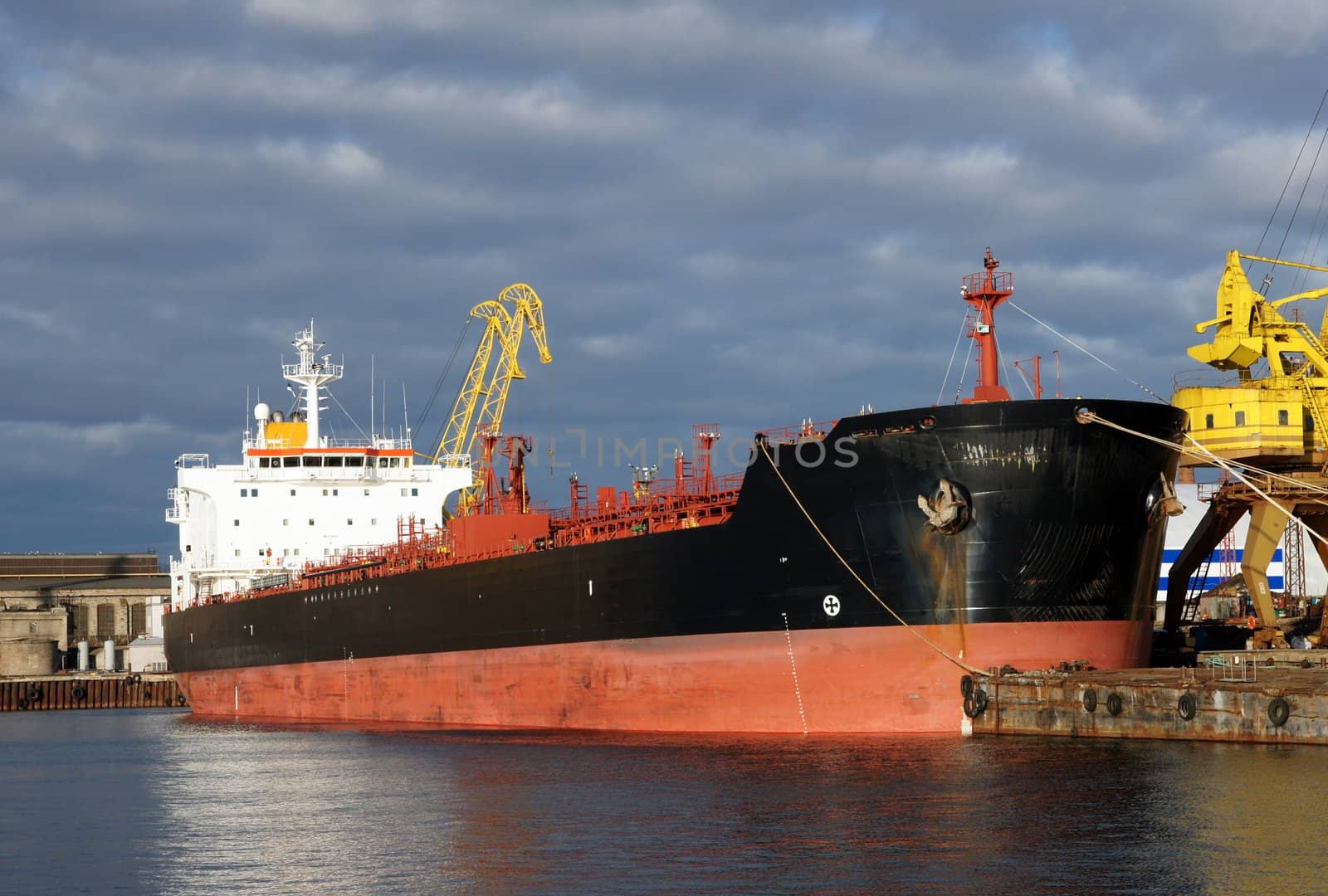 The tanker is moored in the port and loaded fuel