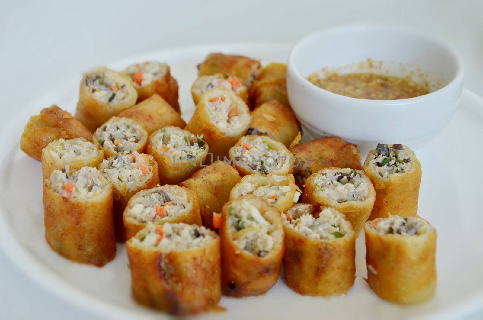 Chinese spring rolls on plate served with sweet sauce