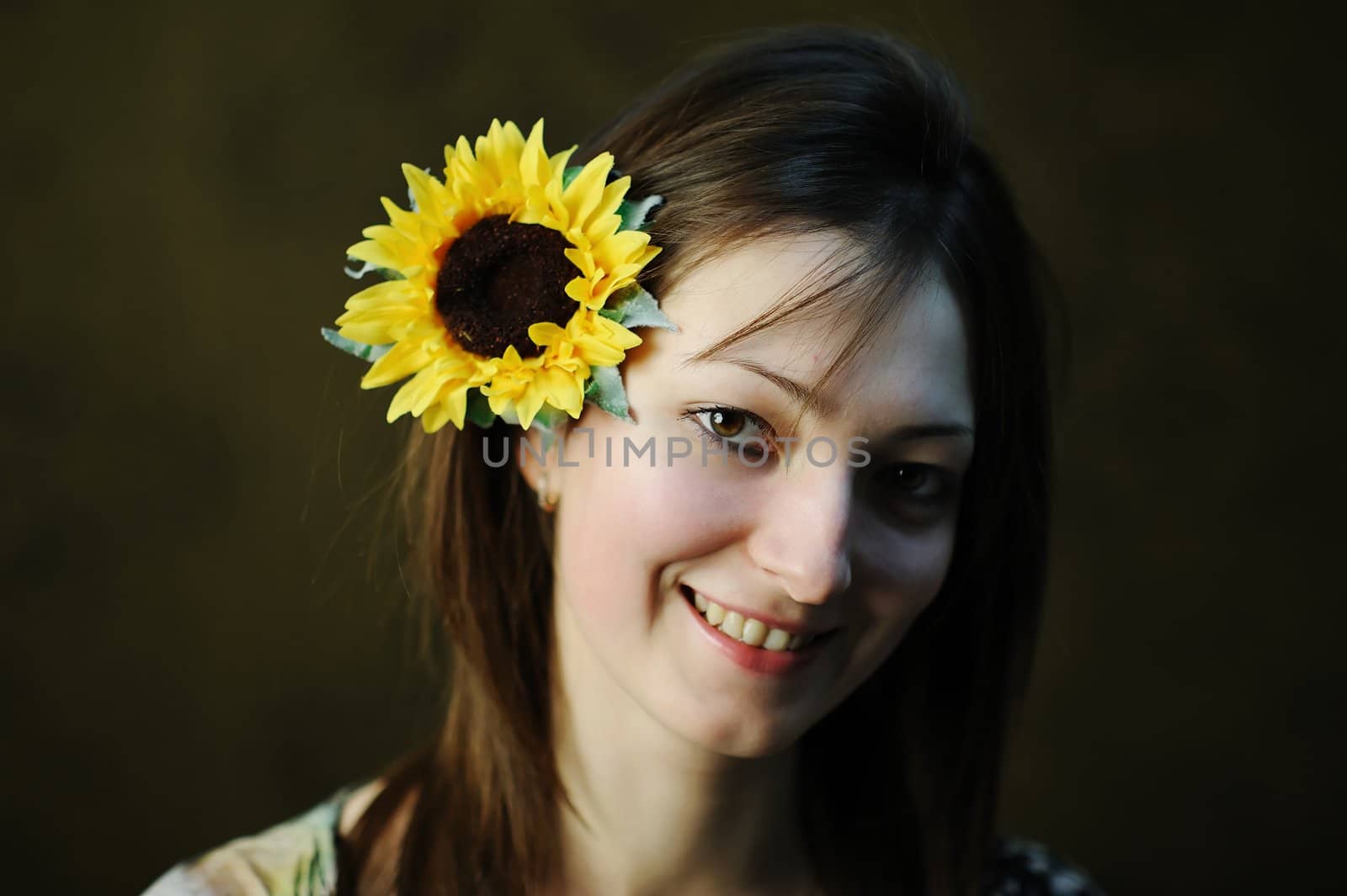 A beautiful woman with yellow sunflower in her hair