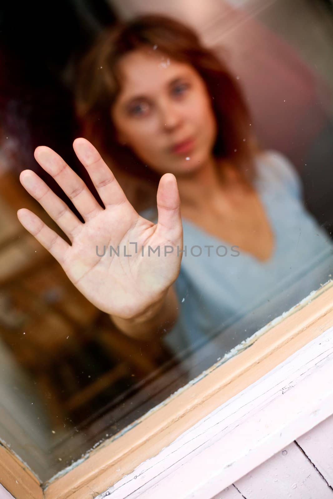 Young women with outstretched hand. In the glass.