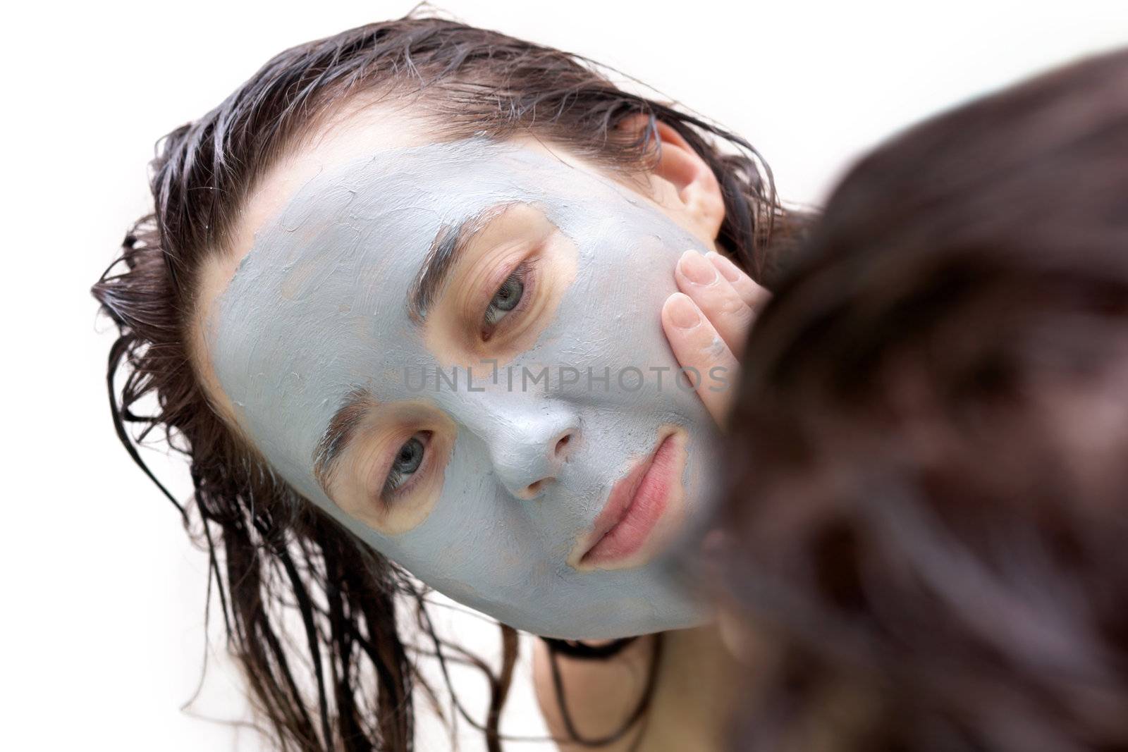 Girl putting a mud mask by velkol