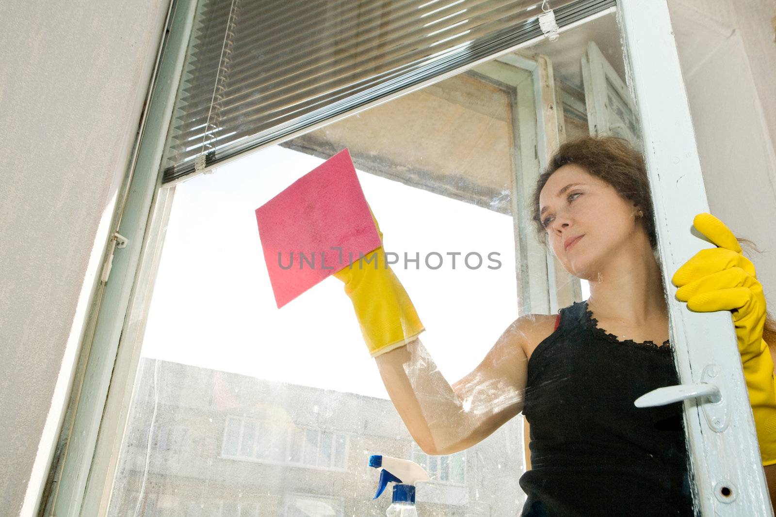 An image of a woman cleaning the window