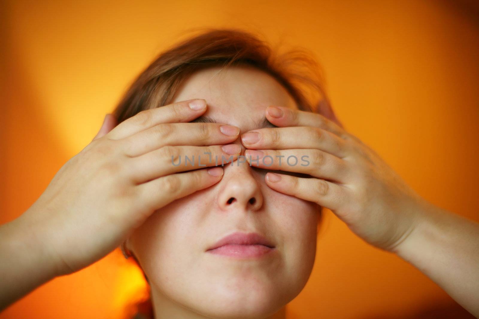 A woman with her hands on her face