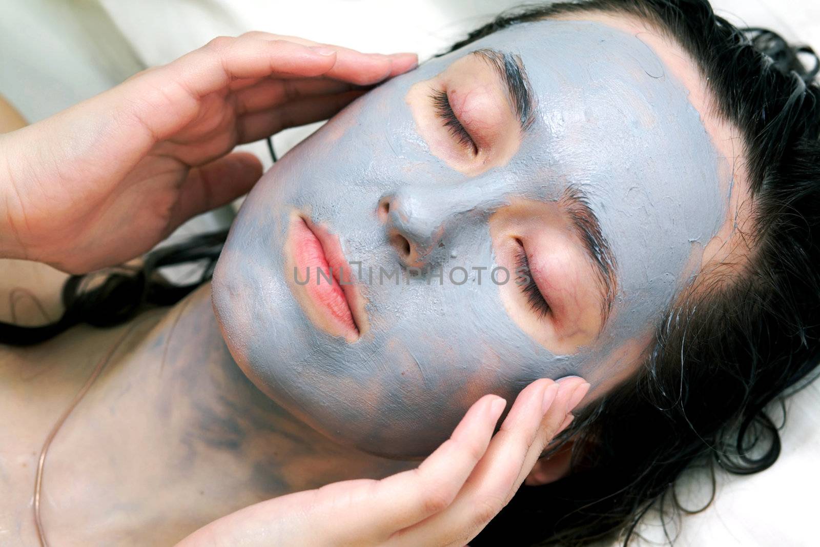 A woman putting a mud mask
