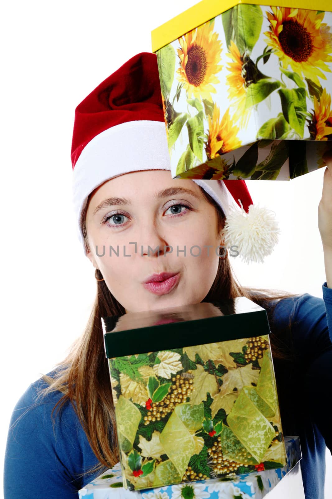 A surprised girl in a new year cap with  boxes