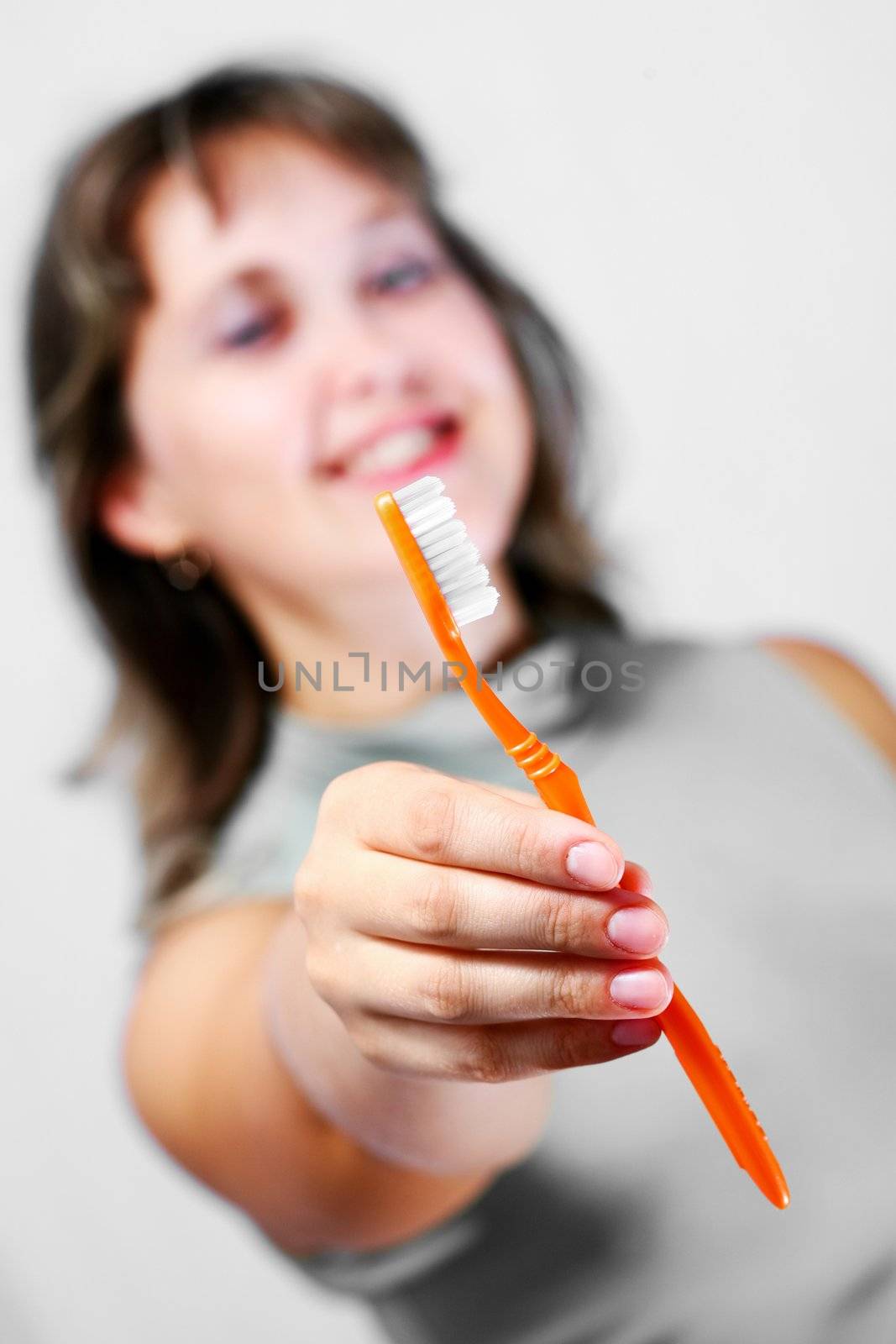 An image of nice woman with toothbrash in hand