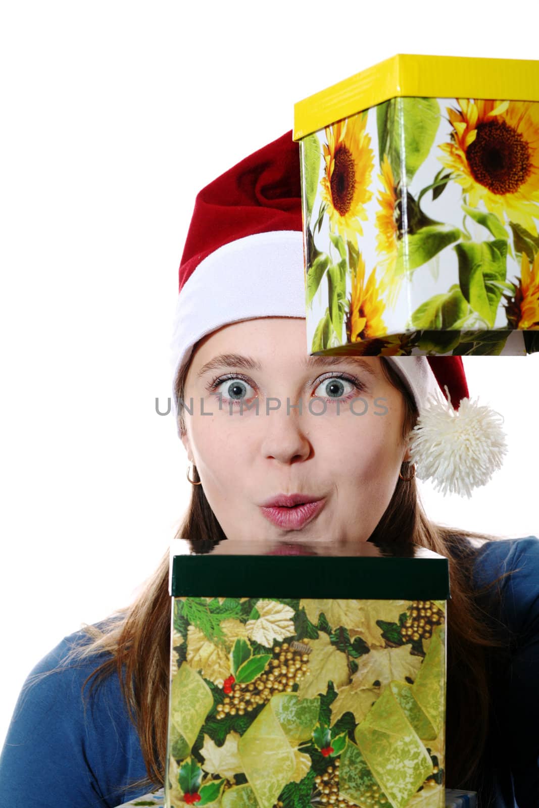 A surprised girl in a new year cap with two gift boxes