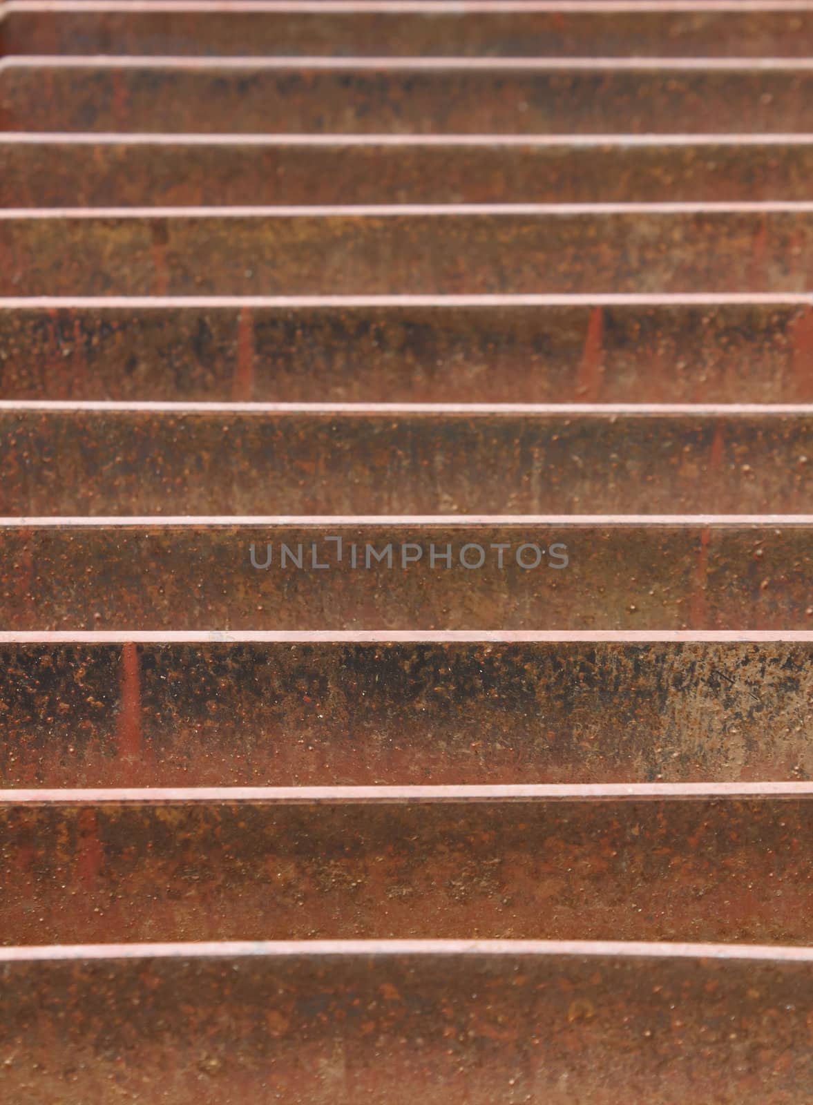 Abstract view of a rusted metal storm drain on street