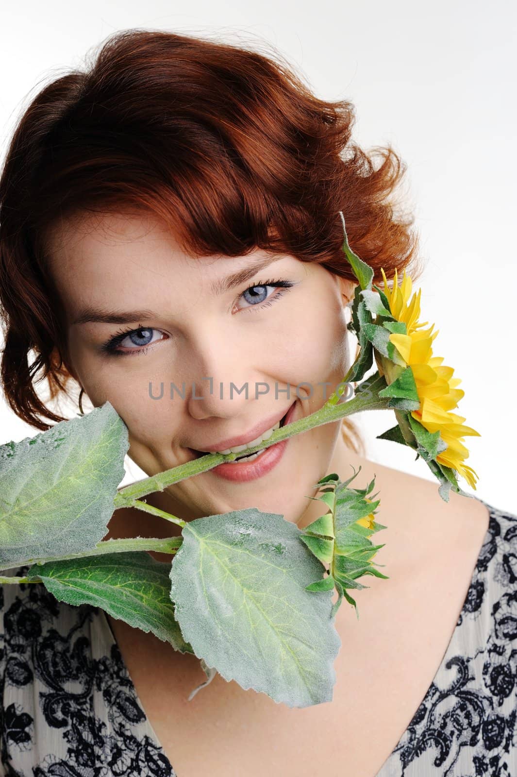 An image of young woman with yellow flower