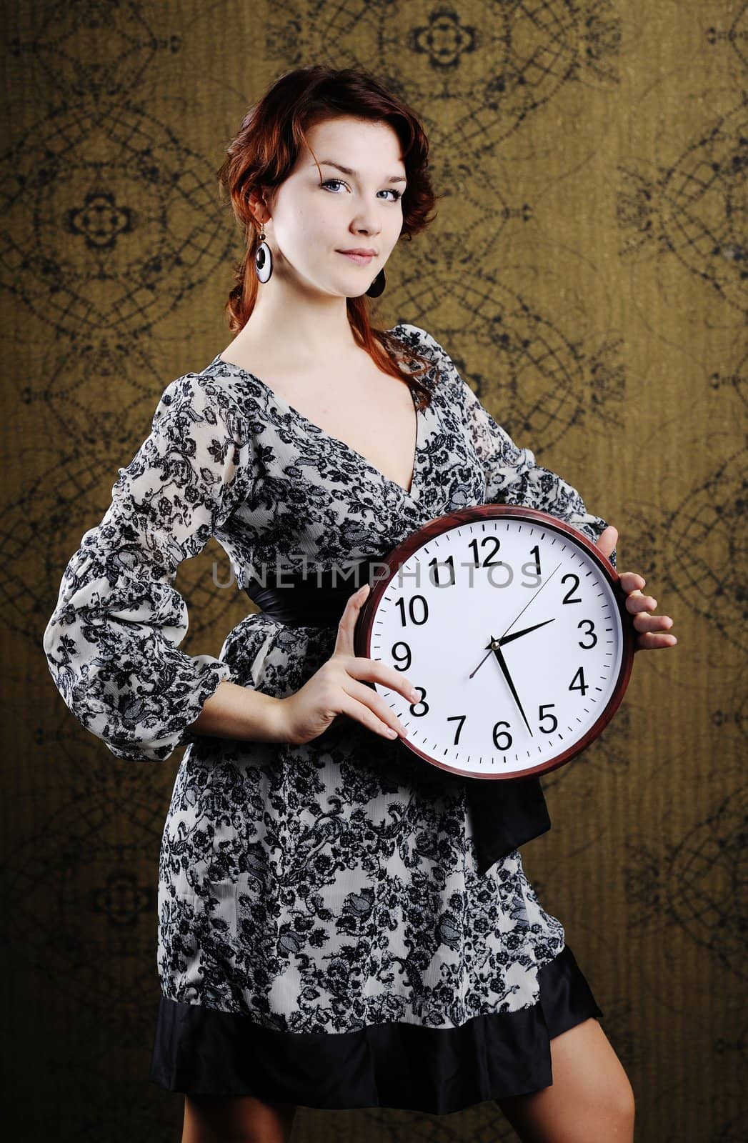 An image of a woman with a big clock