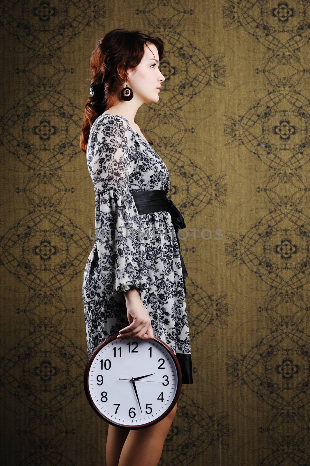 An image of a woman with a big clock