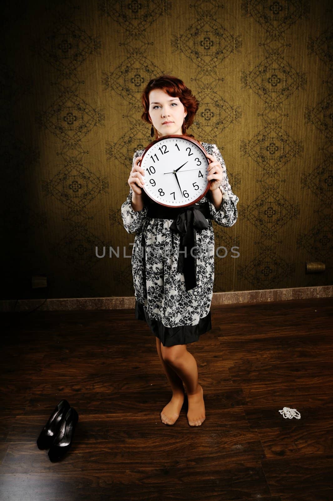An image of a woman with a clock