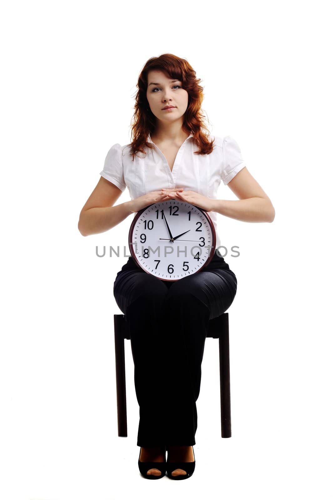 An image of a woman holding a big clock