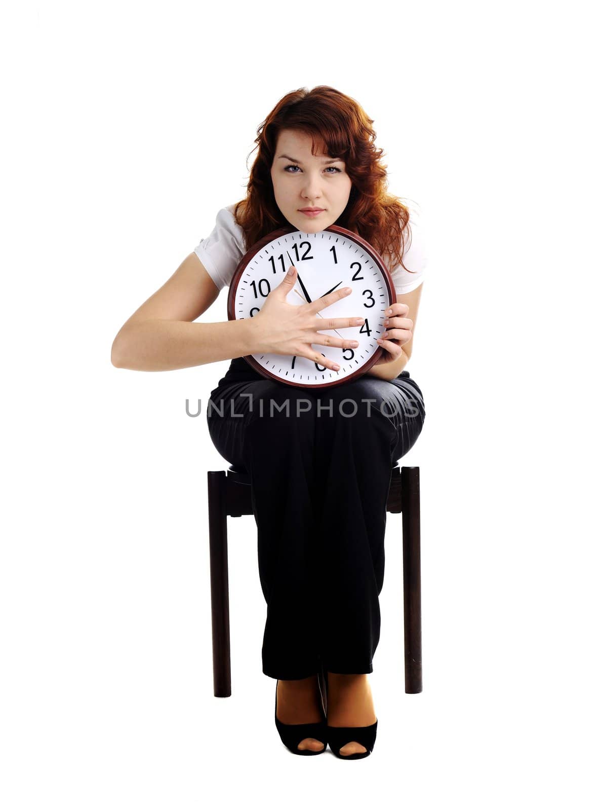 An image of a woman holding a big clock