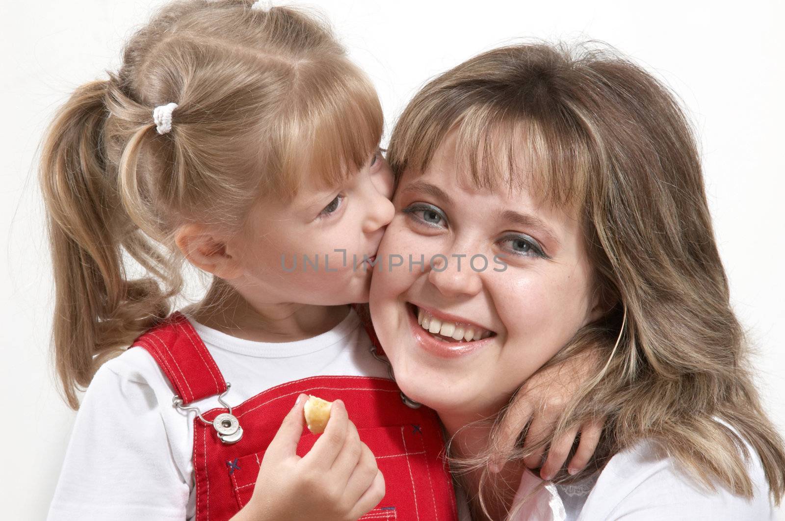 A girl kissing her glad mother