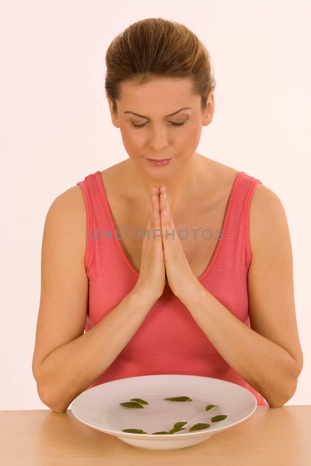 Young woman meditating by inhalation of herbal scent