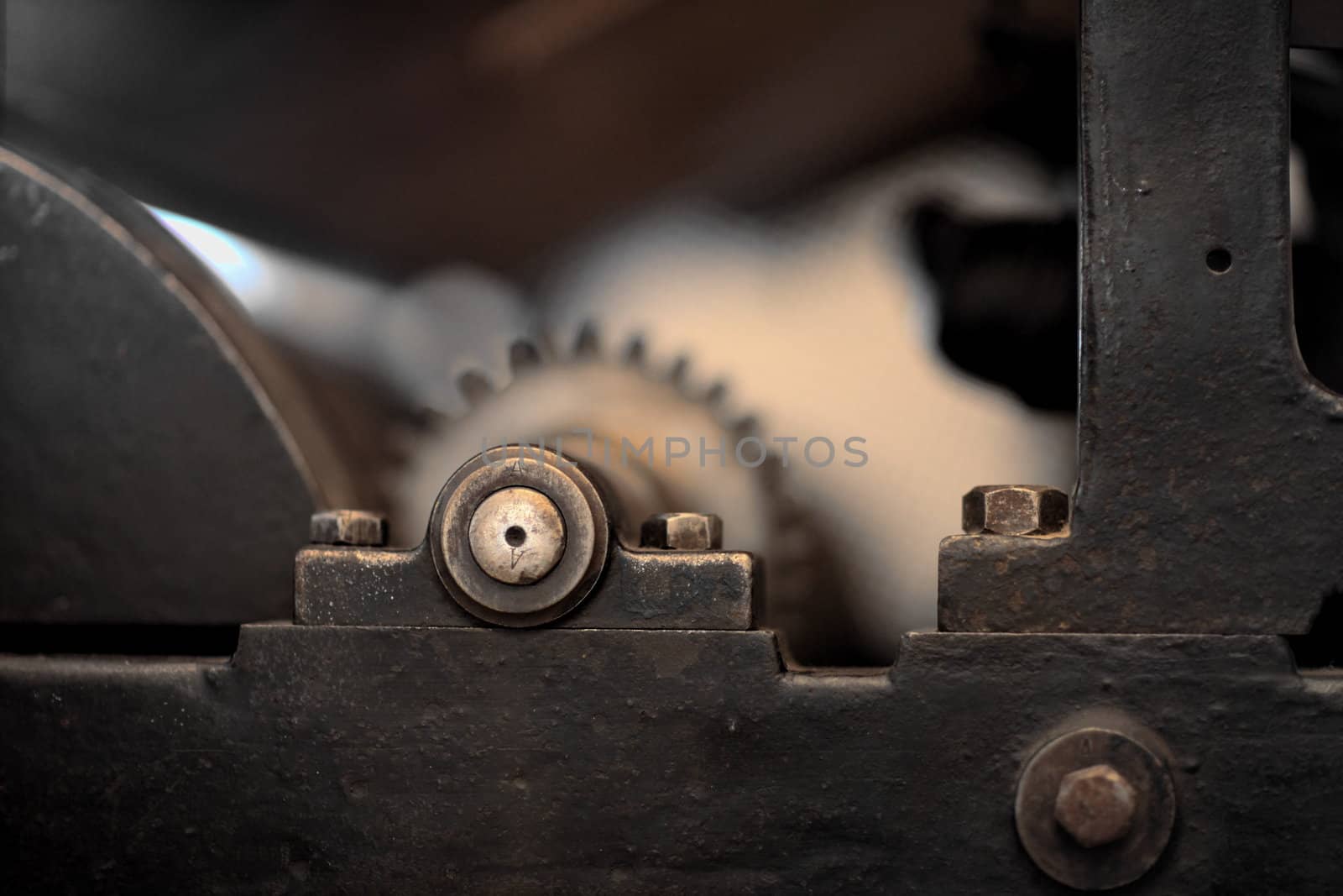 The mechanism of gear wheels, fragment of an antique printing press, close-up