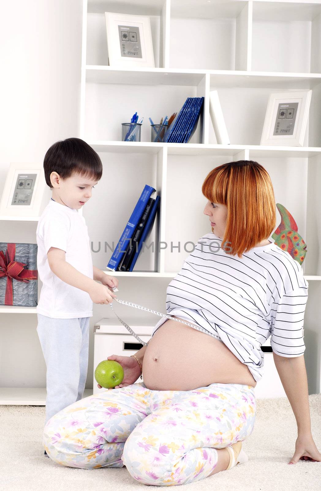 portrait of a pregnant woman and her son, at home