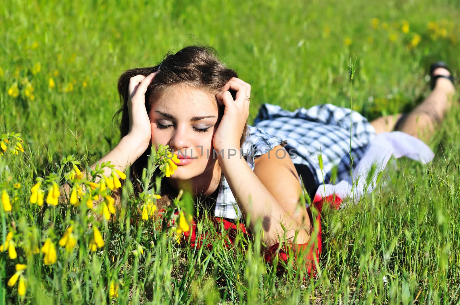 beautiful teen girl relaxing on the spring meadow 