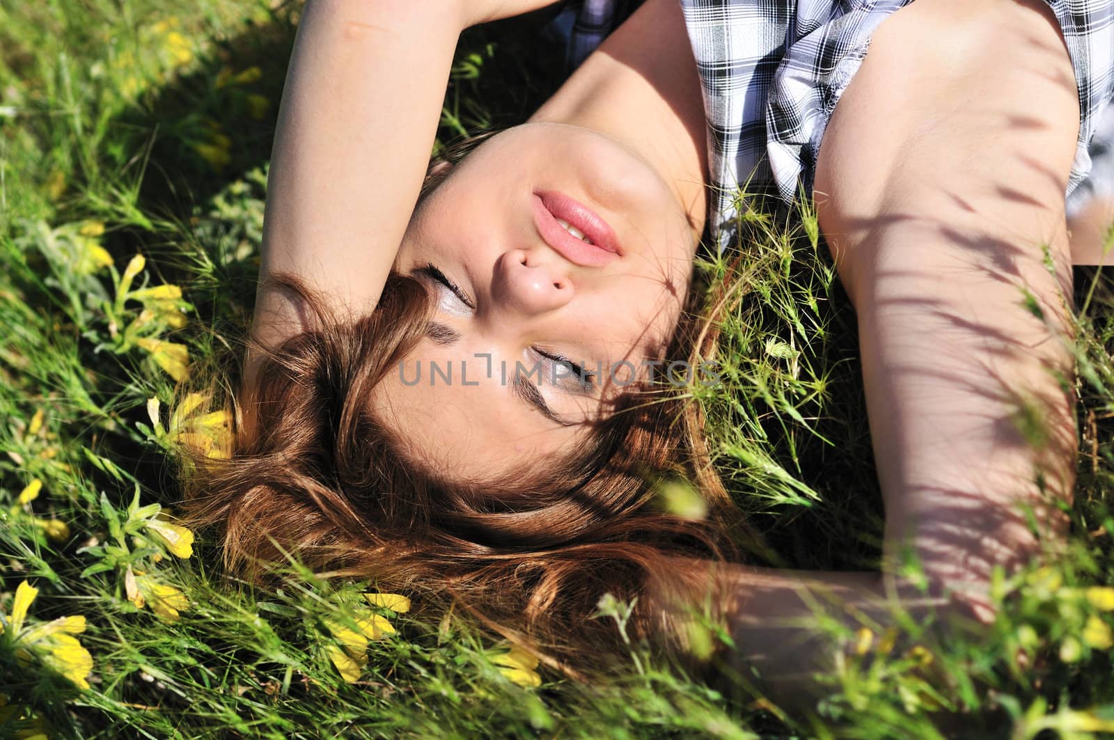 tender girl resting on the spring meadow