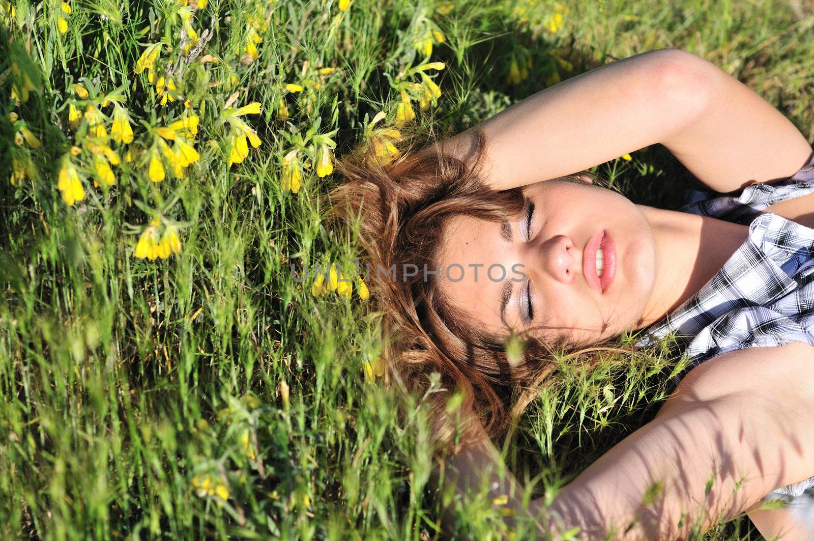 tender girl resting on the spring meadow 