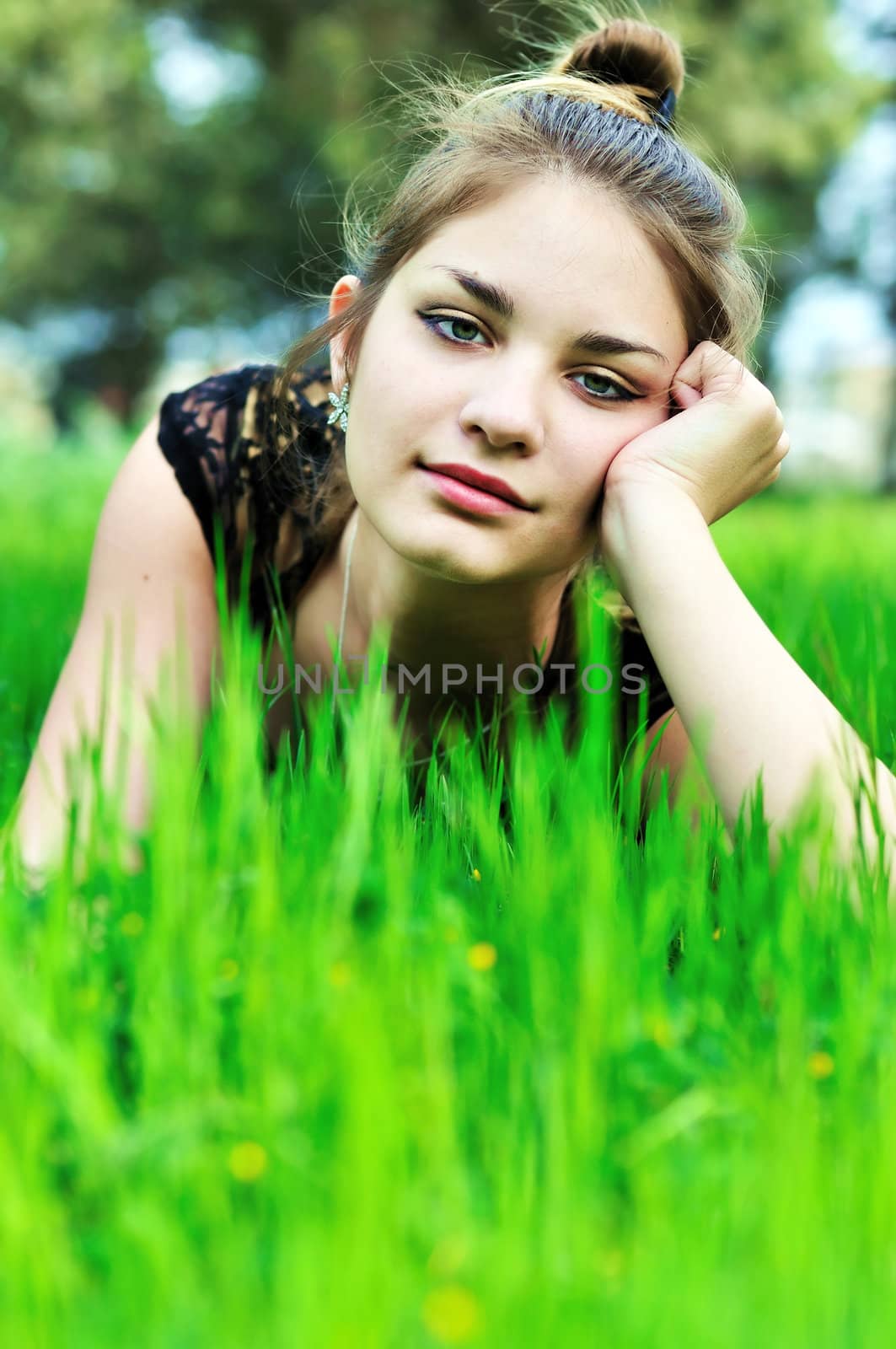 elegant teen girl laying on the meadow