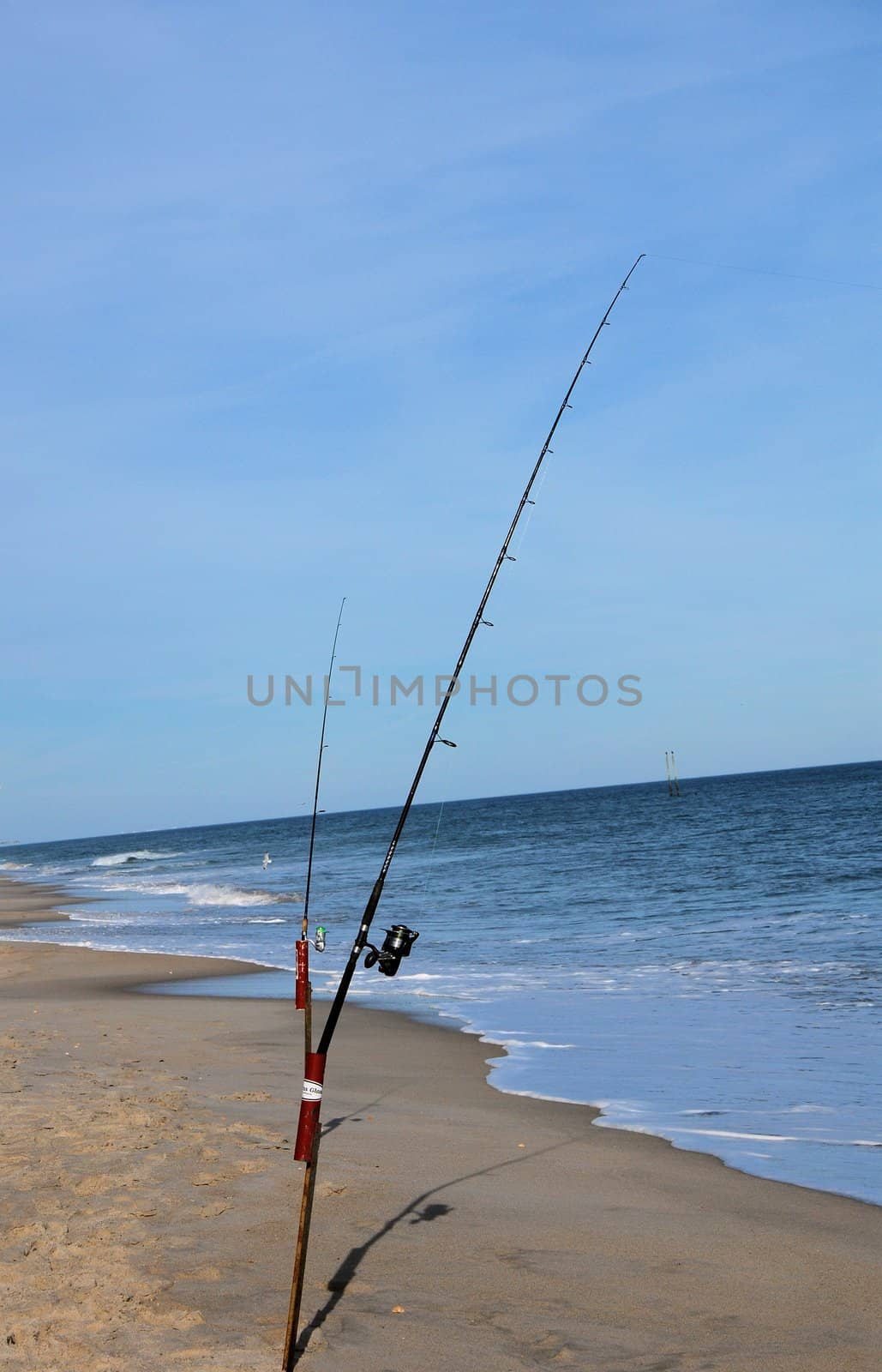 A surf fishing pole along the shore in North Carolina