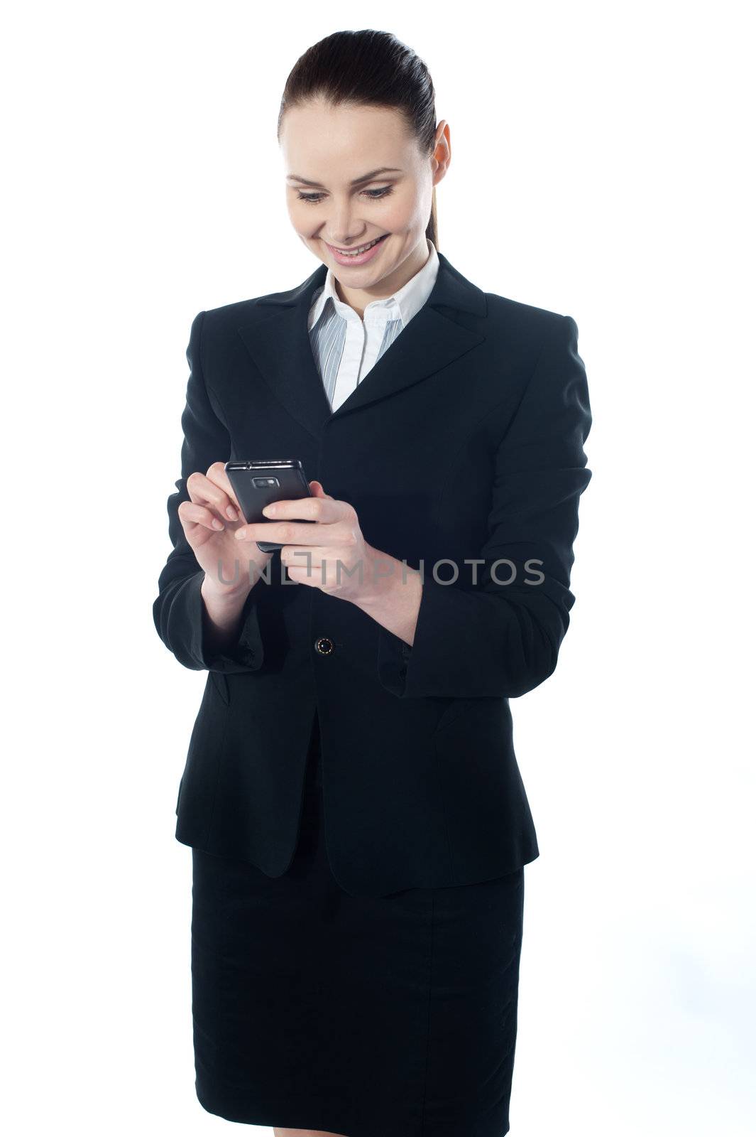 Confident businessperson messaging and smiling