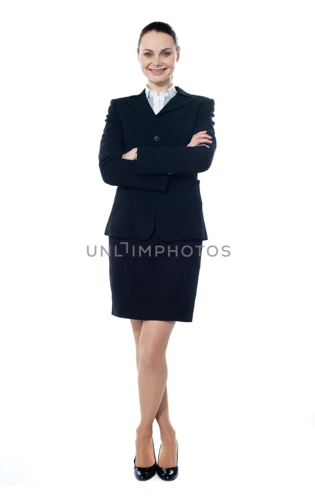 Smiling successful businesswoman posing with folded-arms and crossed legs