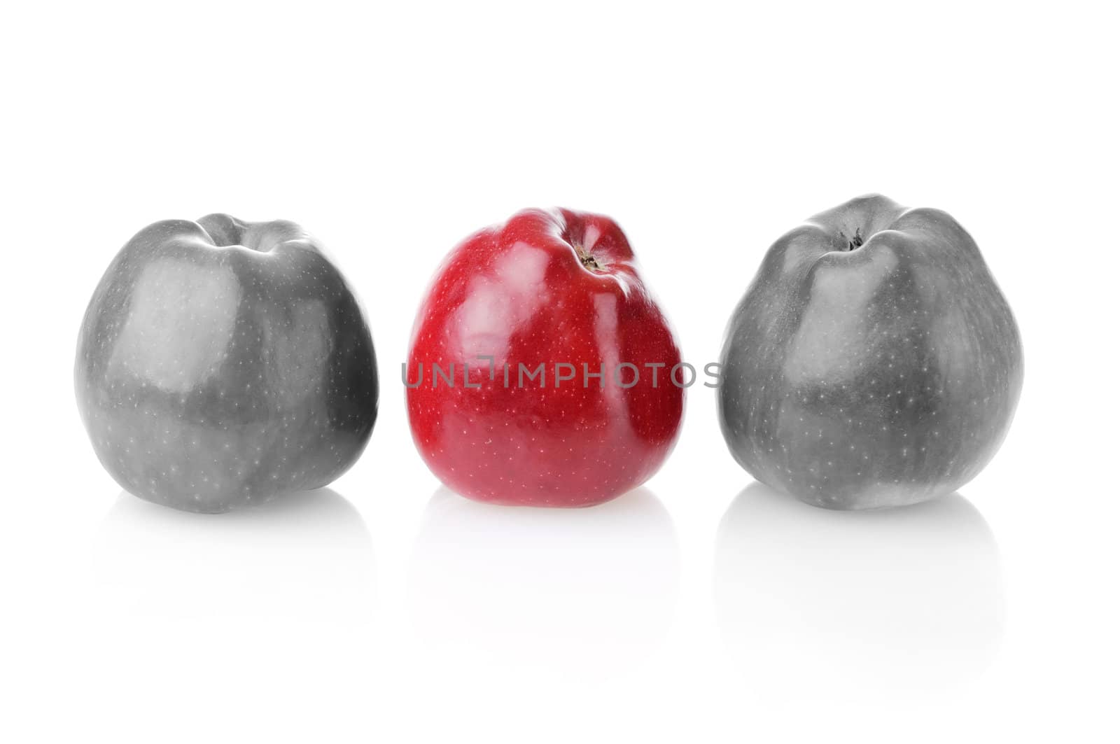 Different bright red apple between two colourless apples on white background