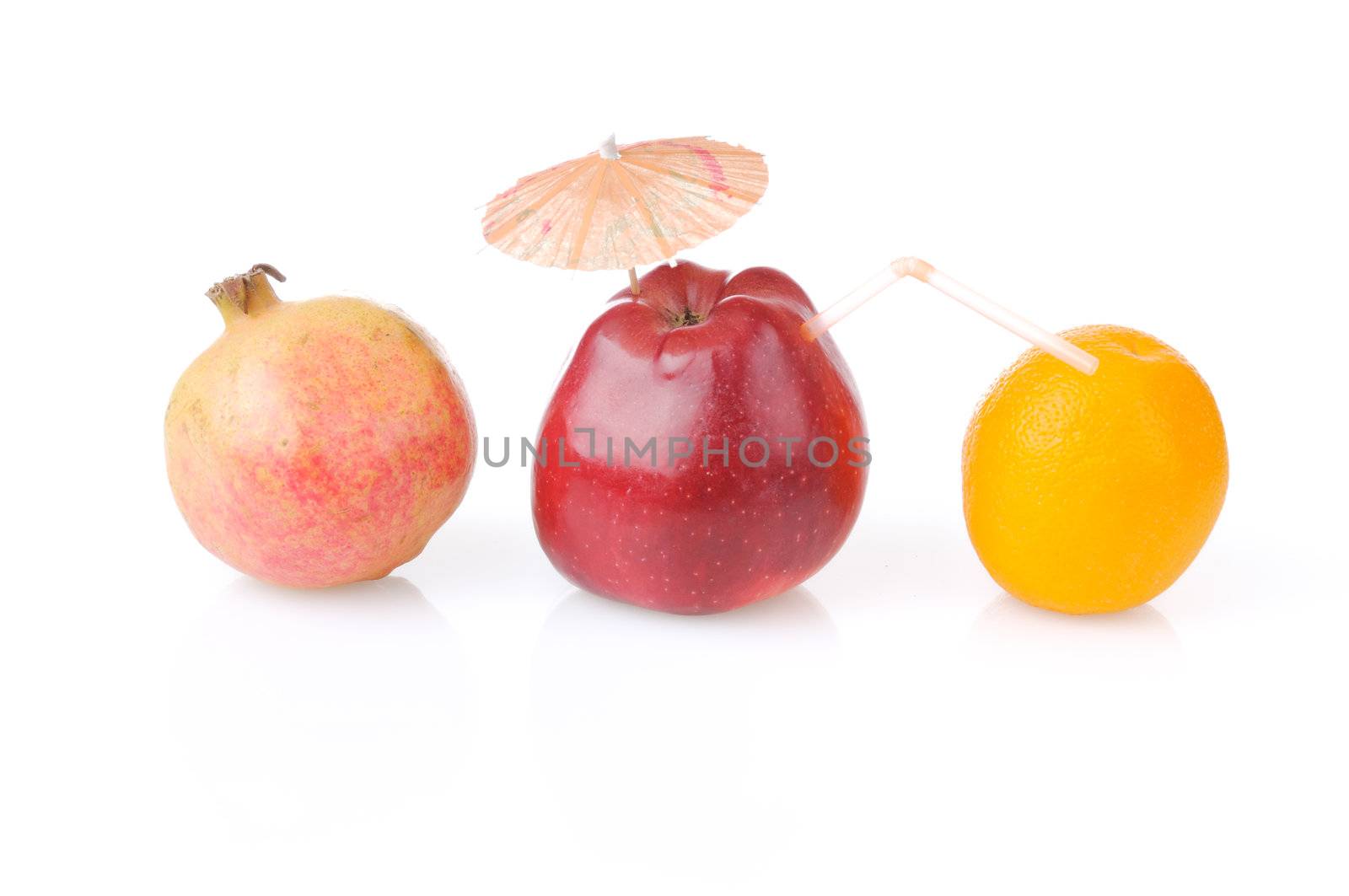 Red apple with umbrella and tube, one pomegranate and orange