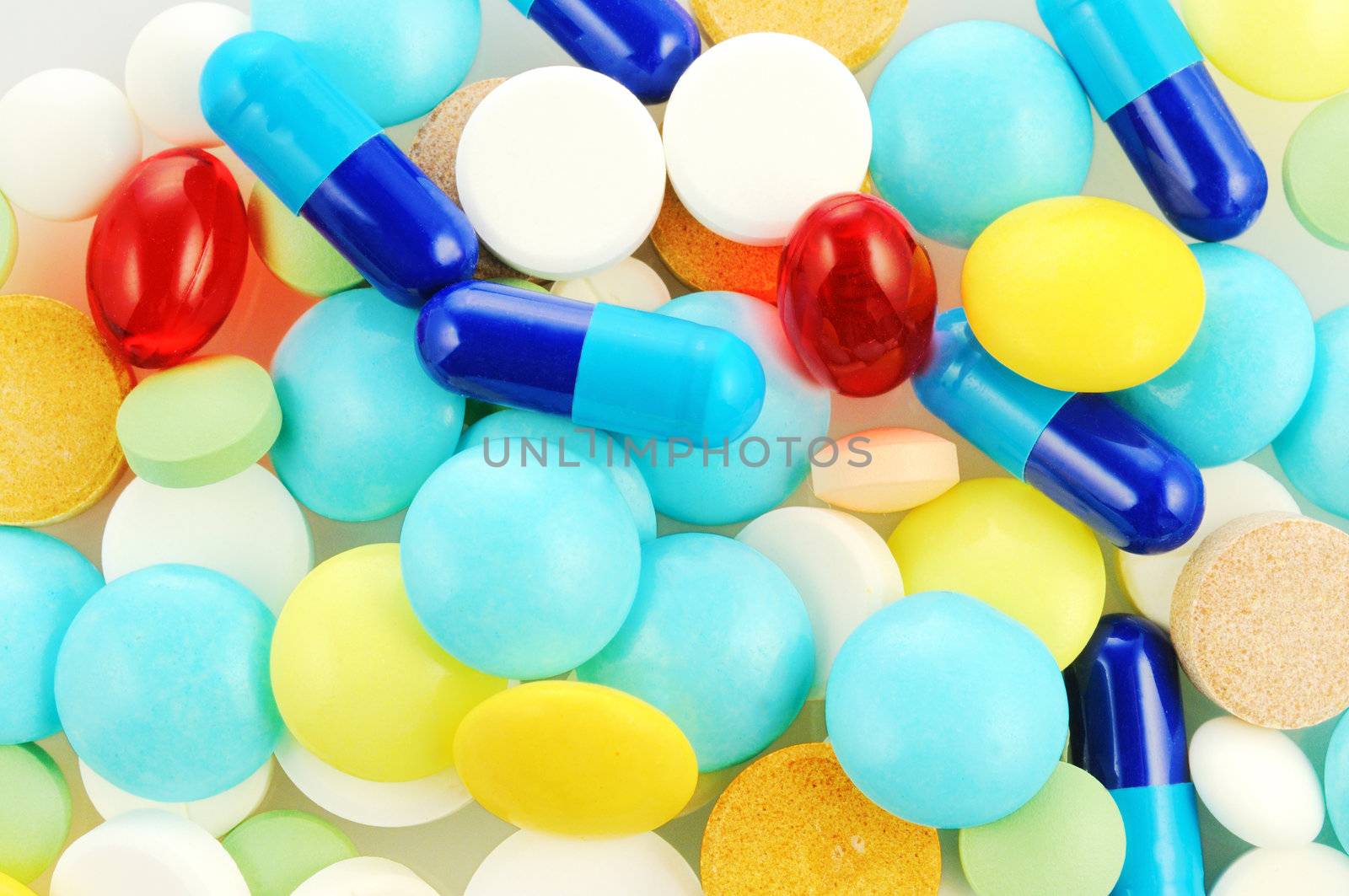 Background with different colour tablets abd pills