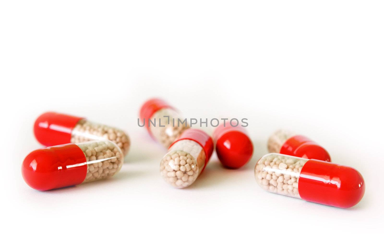 Seven capsules with transparent part and granules insite