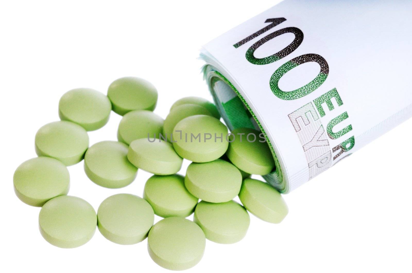 Green round pills fall out a sheaf of 100 euro papers