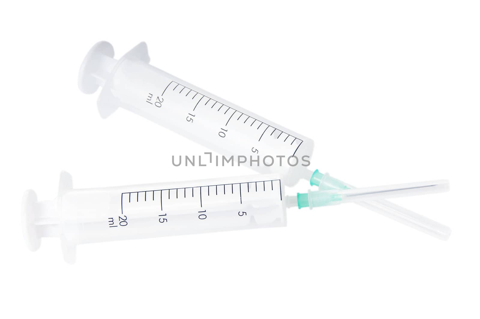 Two syringes with covered needles isolated on white background