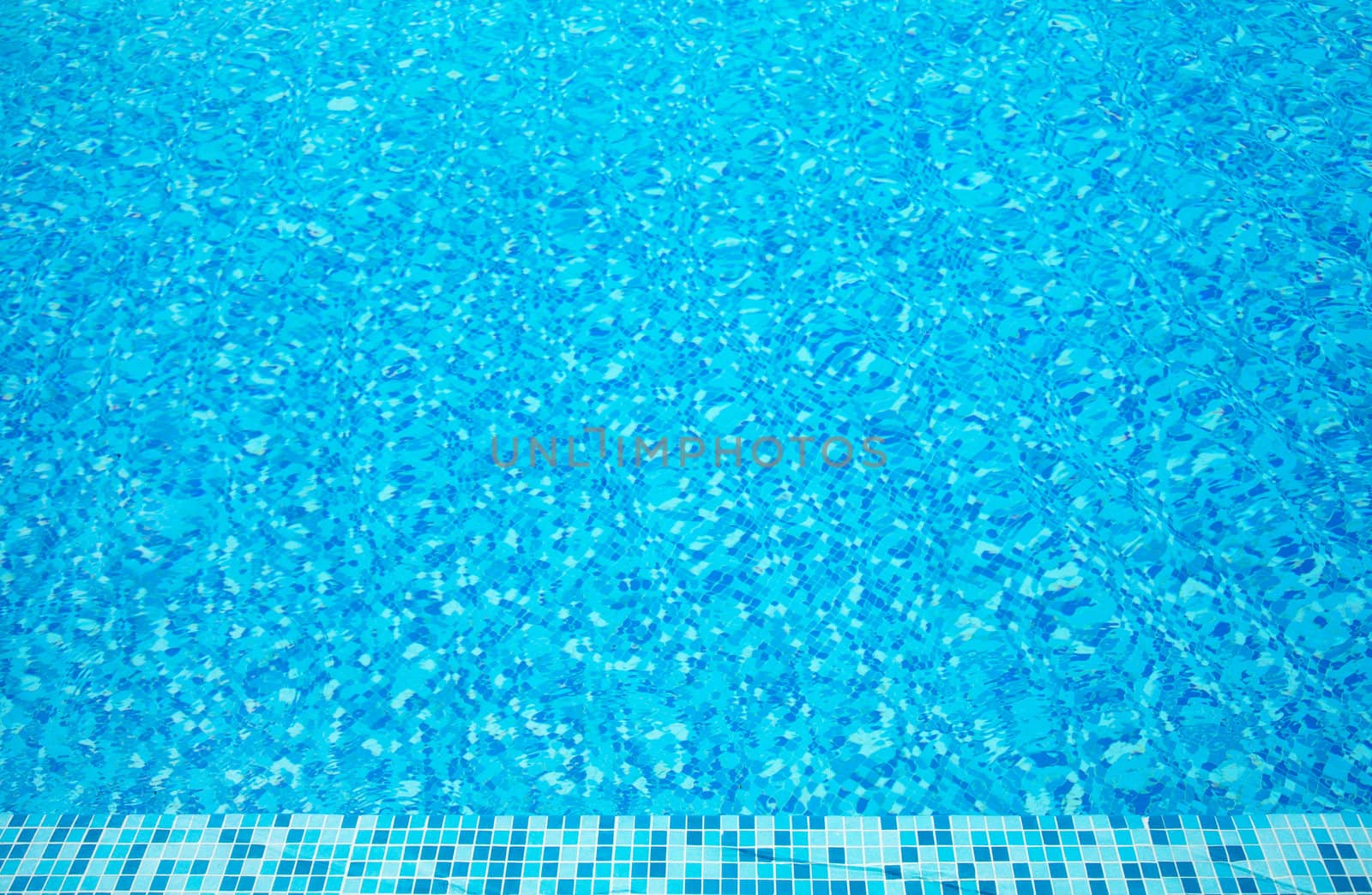 Part of swimming pool with blue clear water 