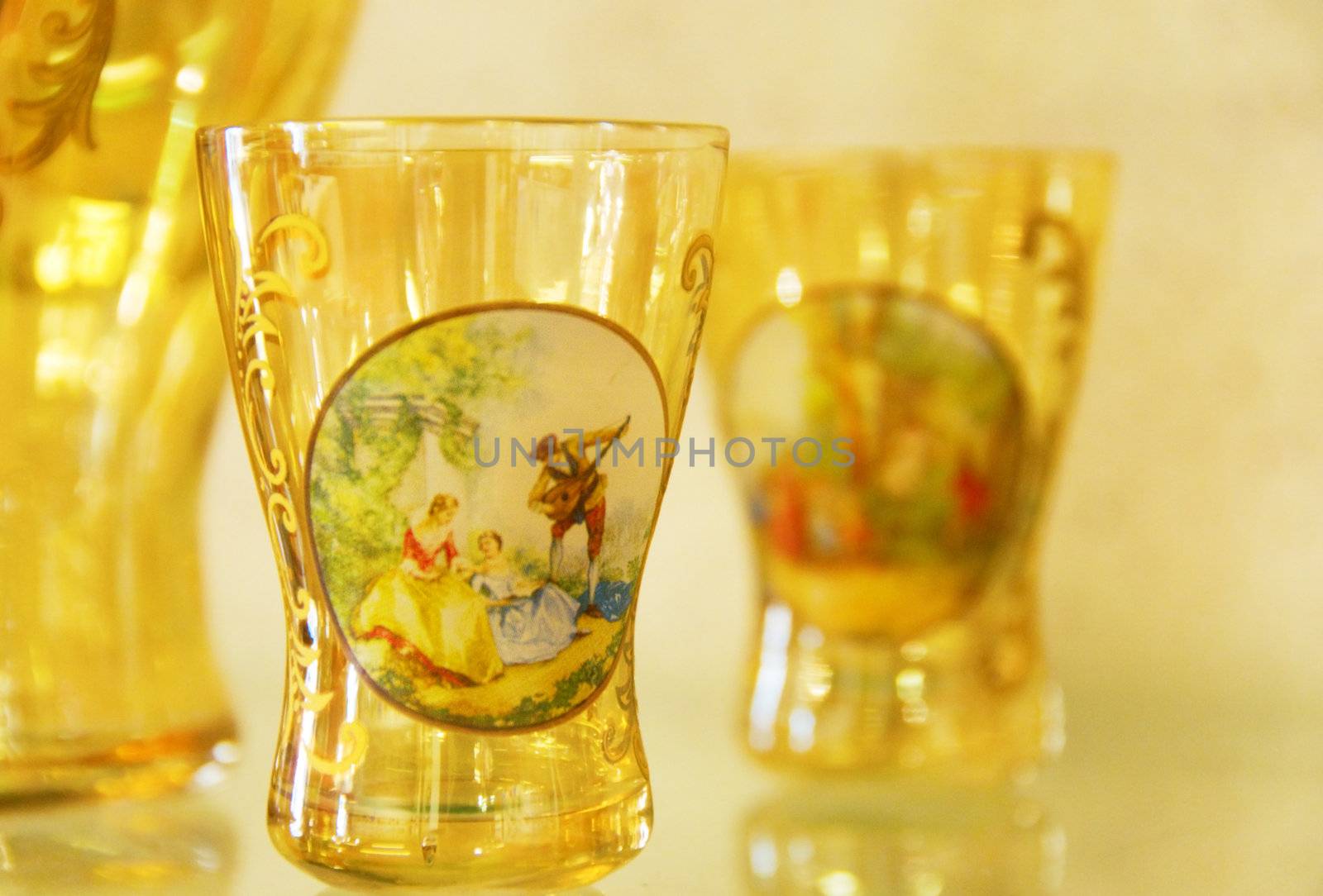 Transparent gold hand-made glass covered with drawing. Shallow depth-of-field