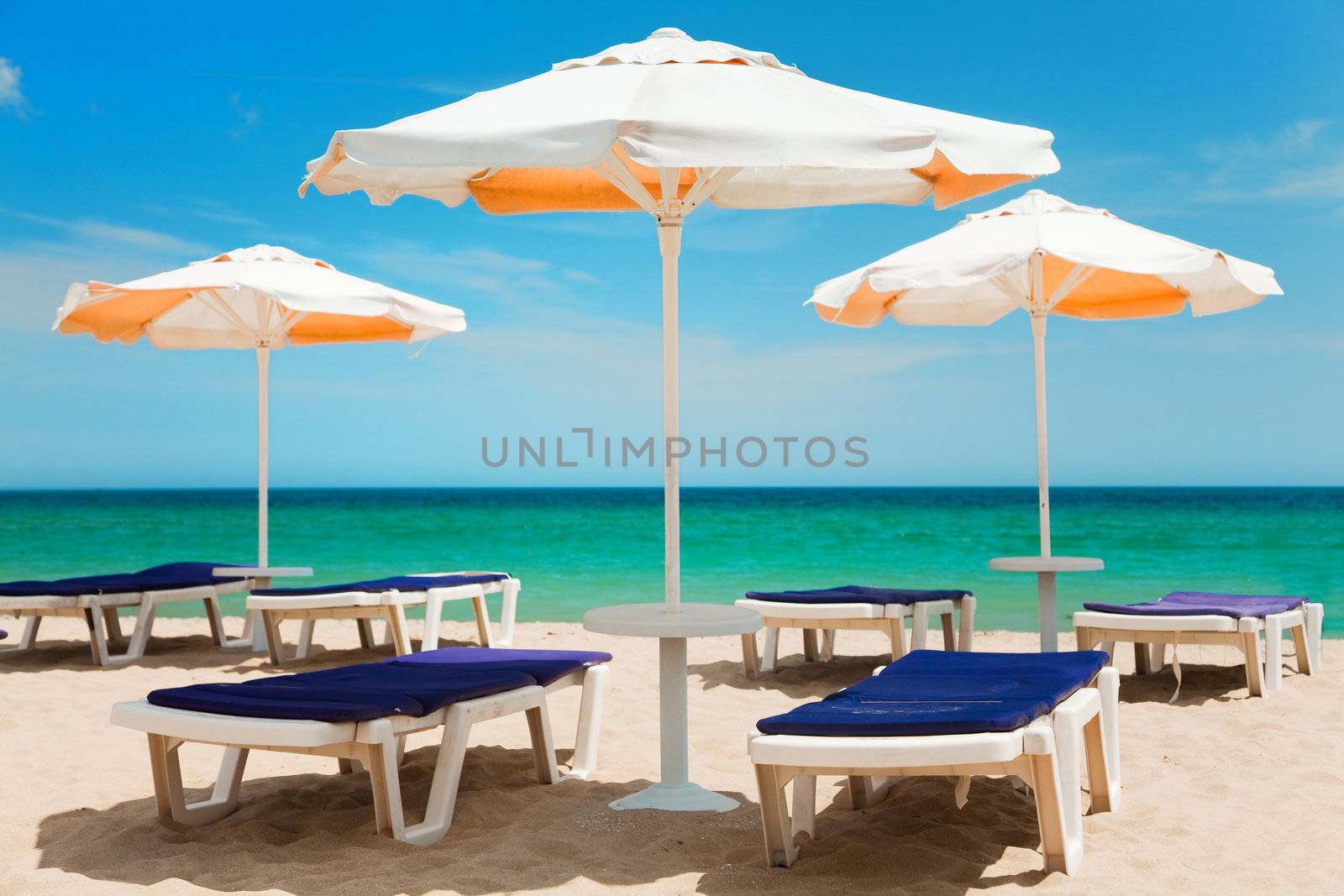 Umbrellas and chairs on beautiful tropical beach 