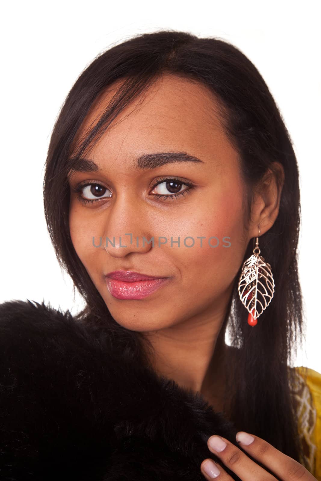 Mulatto young woman in furs on white background