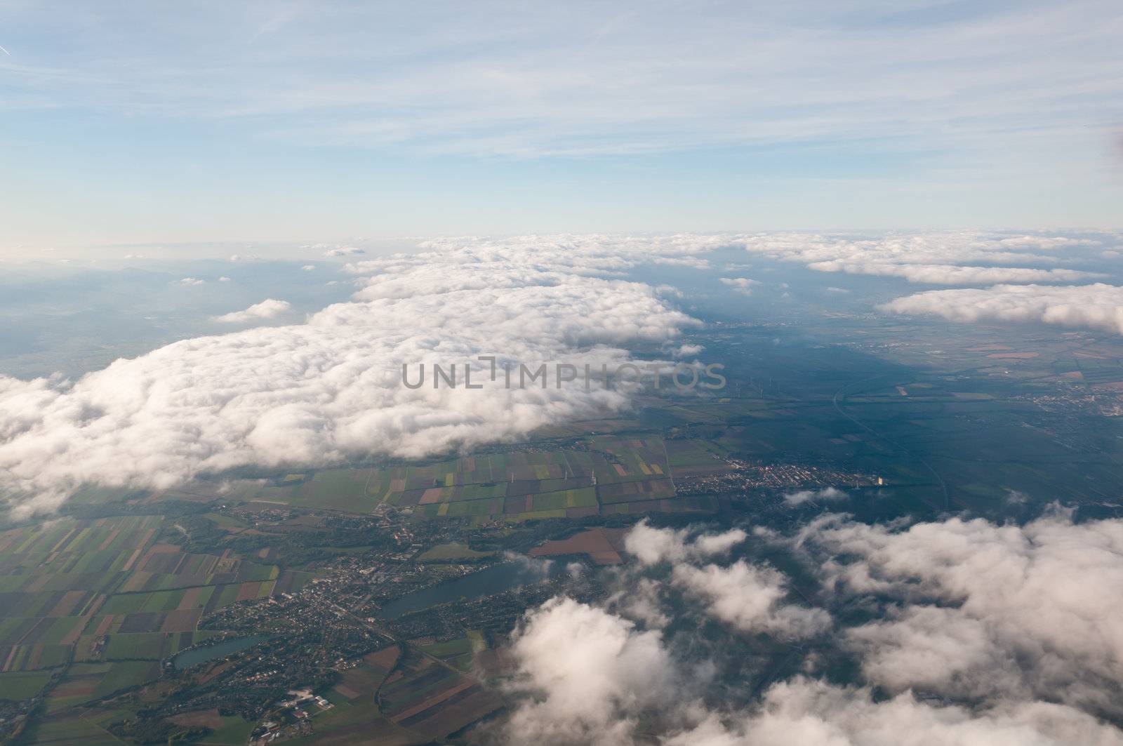 Aerial view of Austria above cloudscape and fields